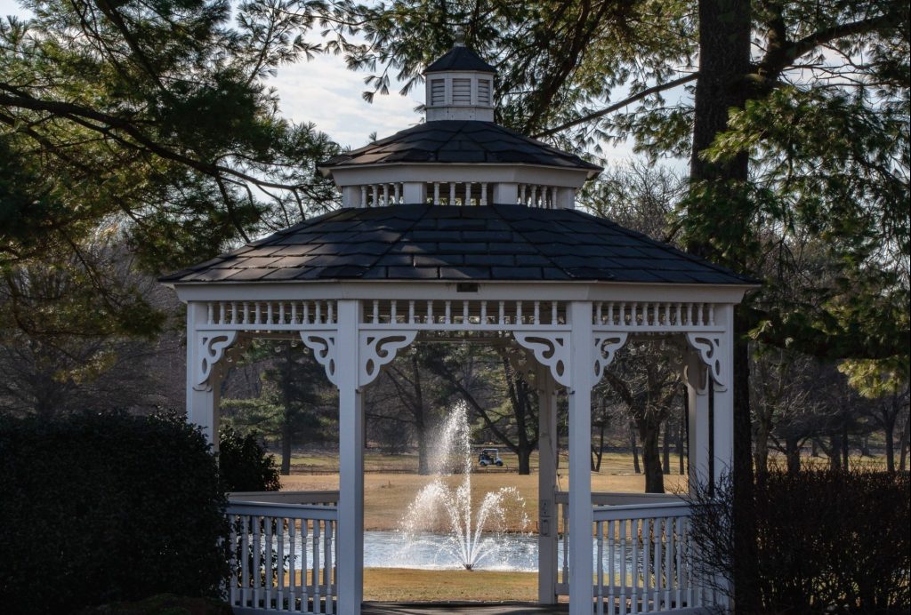 Gazebo on golf course in front of fountain